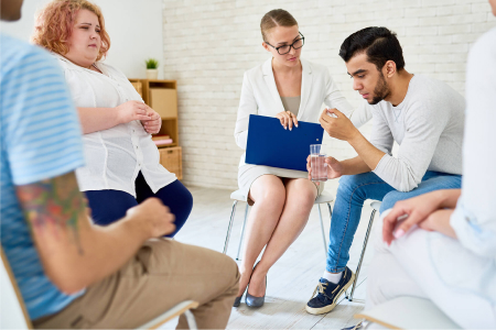 young-man-opening-up-in-group-therapy-session-KA6ABSR